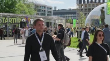 İş konferansı sırasında parkta yürüyen insanlar