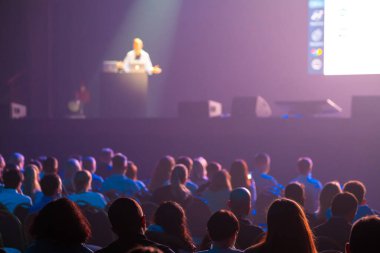 İş konferansı sırasında konuşmacıları dinleyen tanınmayan insanlar