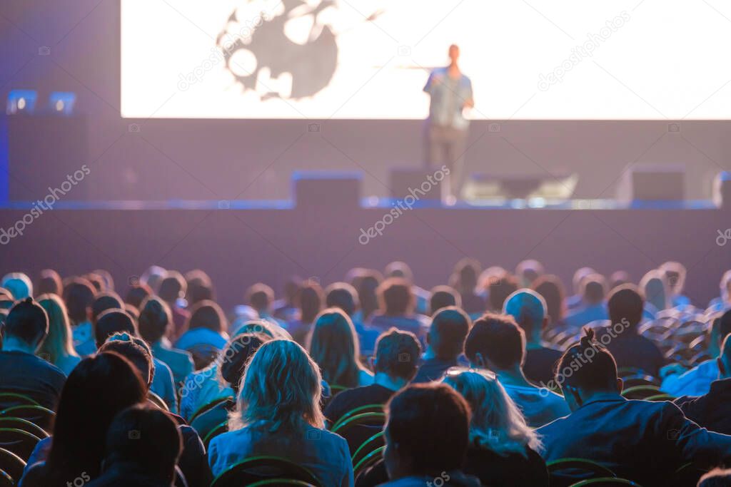 Audience sitting near illuminated stage