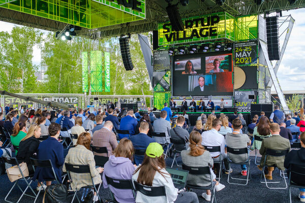 Participants of open air conference listening to speaker