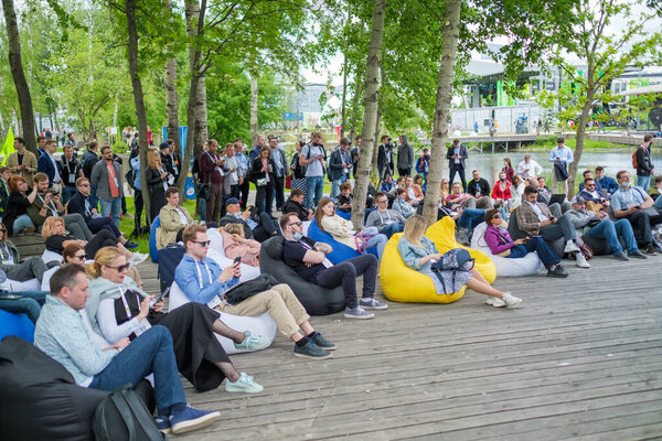 Crowd listening to lecture in park