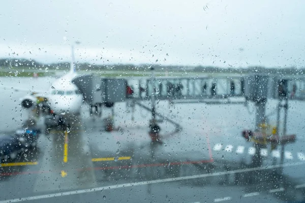 Aeródromo do aeroporto atrás de vidro molhado — Fotografia de Stock
