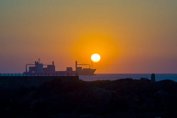 Cargo ship at sunset — Stock Photo, Image