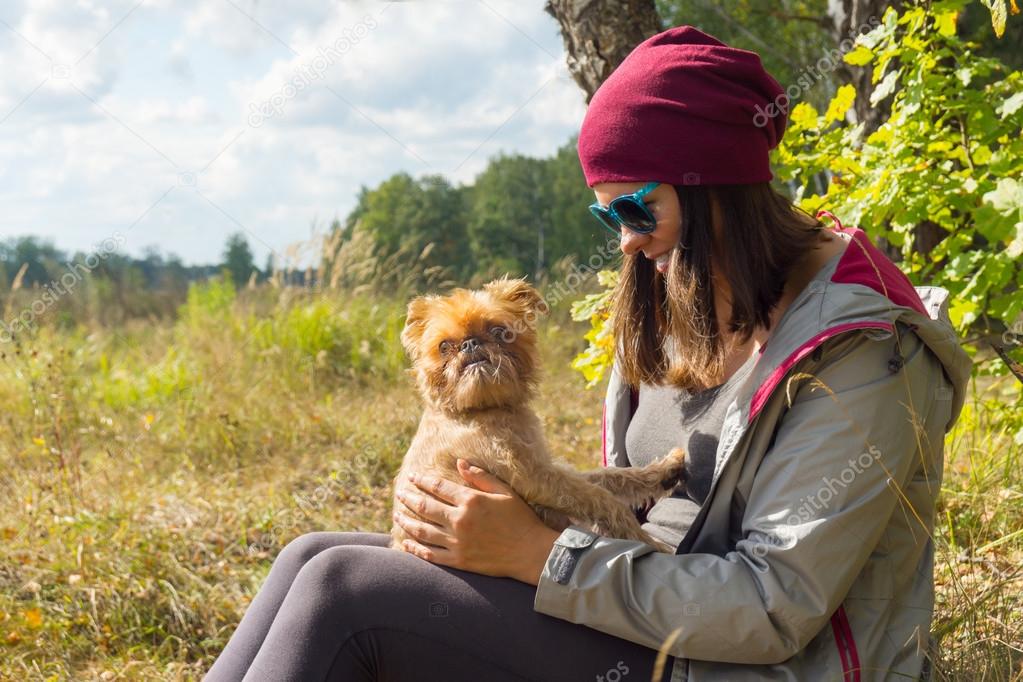 Young woman plays with small dog