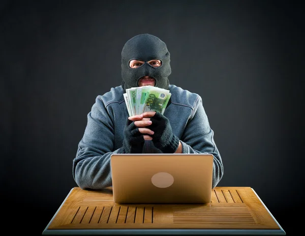 Happy cybercriminal man holding euro cash — Stock Photo, Image