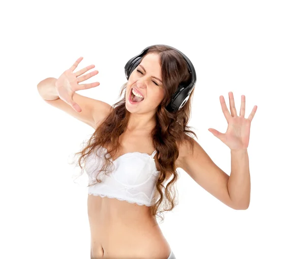 Young slim brunette girl listen music in headphones — Stock Photo, Image