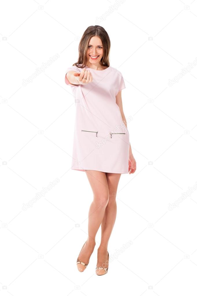 Young slim pretty woman in pink dress posing