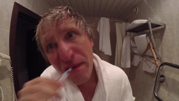 Tired man brushing his teeth — Stock Video