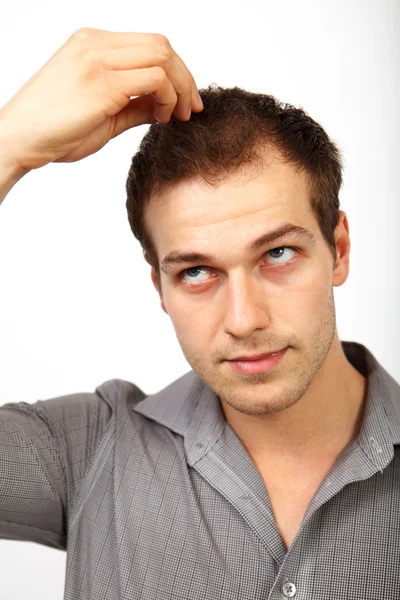 Hair loss concept - young man worried about baldness — Stock Photo, Image