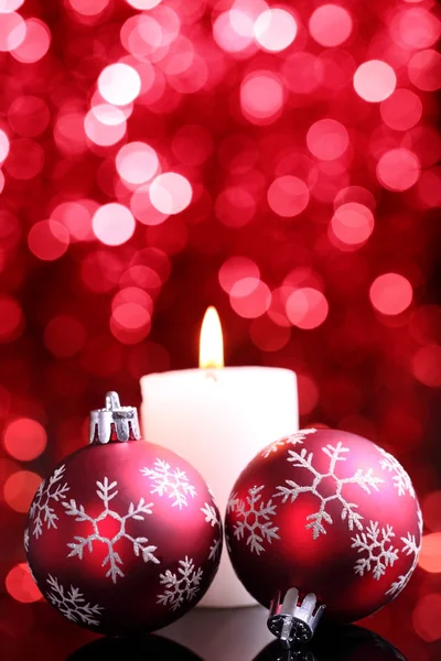 Christmas balls and burning candle — Stock Photo, Image