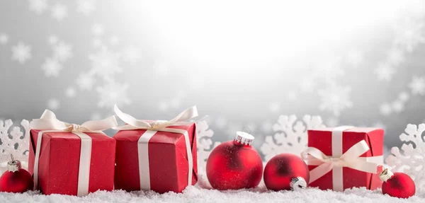 Christmas gifts on snow — Stock Photo, Image