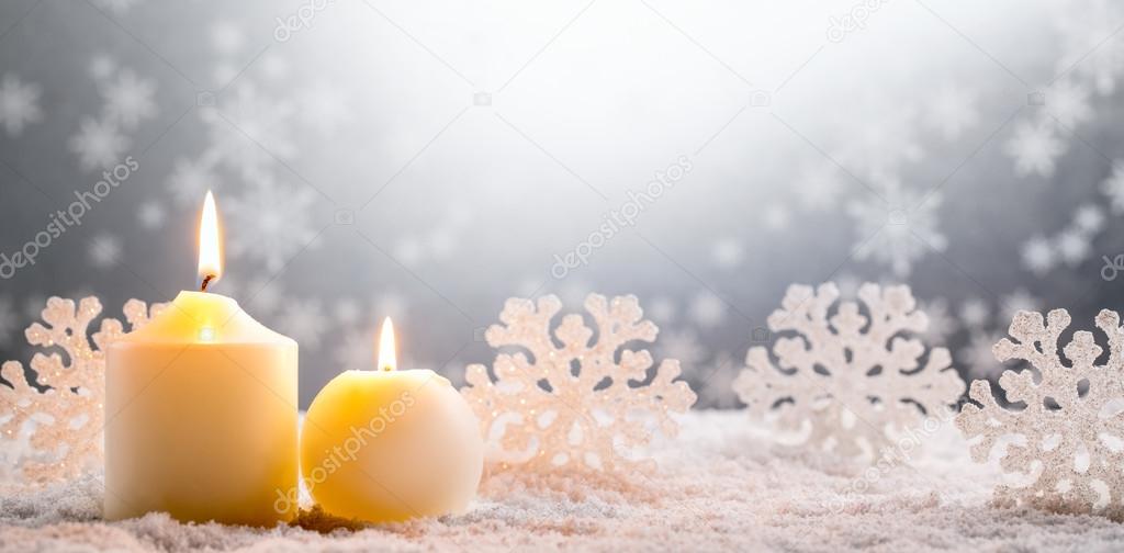 Burning candles on snow
