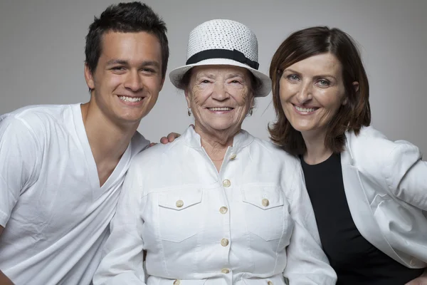 3 generations family in white cloths. — Stock Photo, Image