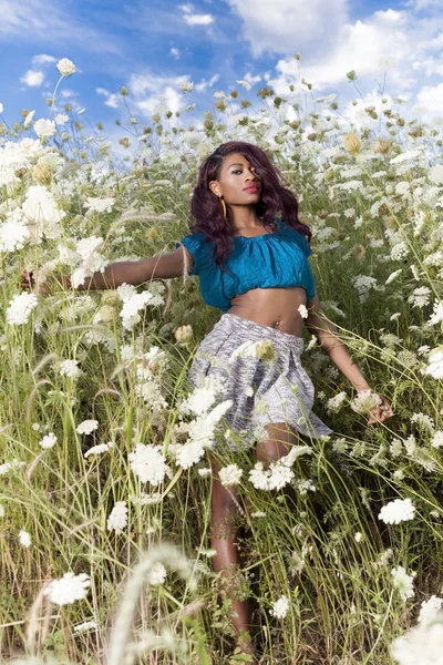 Menina goza de dia quente de verão no campo de flores . — Fotografia de Stock