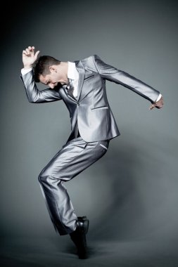 Gri takım elbiseli mutlu işadamı.