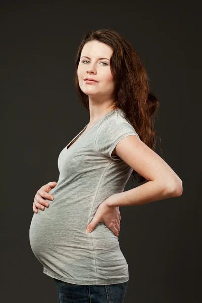 Young expecting mother with long dark hair. — Stock Photo, Image