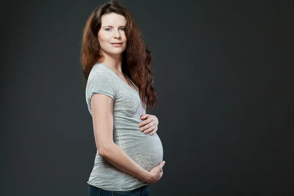 Young expecting mother with long dark hair. — Stock Photo, Image
