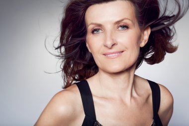 Kıvırcık saçlı mutlu orta yaşlı kadın.