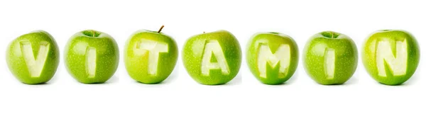 Word "vitamine" gemaakt van groene appels. — Stockfoto