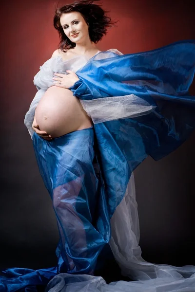 Pregnant woman posing on dark background. — Stock Photo, Image