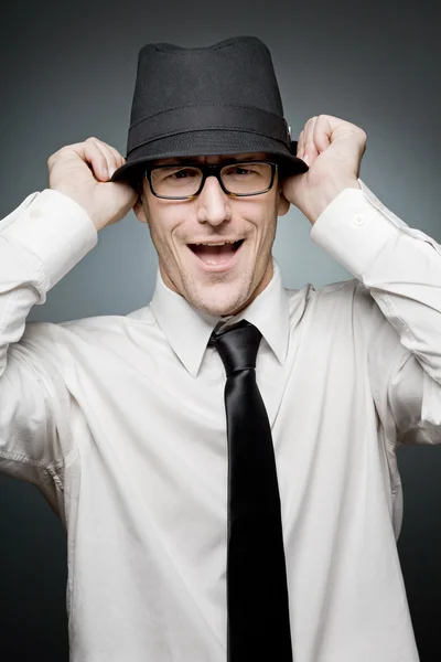 Funny businessman playing with his hat. — Stock Photo, Image