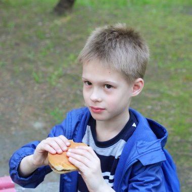 Hamburger yiyen çocuk