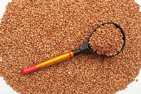 Buckwheat background and spoon — Stock Photo, Image