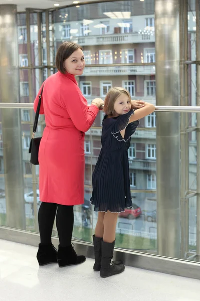 Ggirl with her mother posing in the hall — Stock Photo, Image