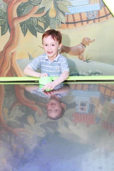 Boy playing air hockey — Stock Photo, Image