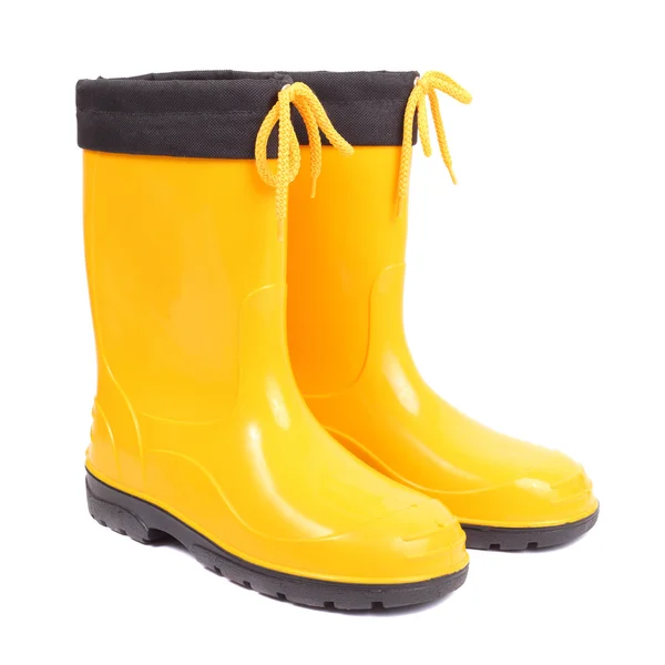Helder gele rubber schoenen — Stockfoto
