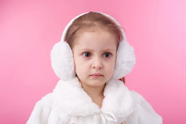 Little child wearing fur earmuffs — Stock Photo, Image