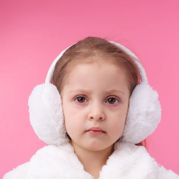 Little child wearing fur earmuffs Stock Image