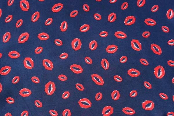 blue textile with lips prints