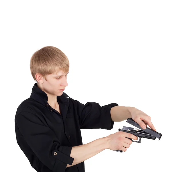 Boy disassembling pistol — Stock Photo, Image