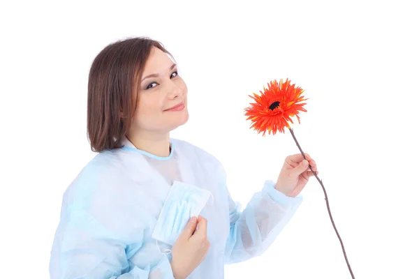 Krásné mladé lékaře s květinou — Stock fotografie