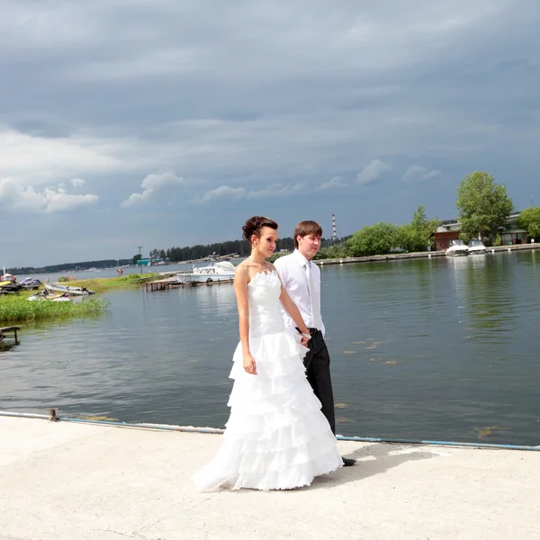 Bride and bridegroom near a lake — Stock Photo, Image