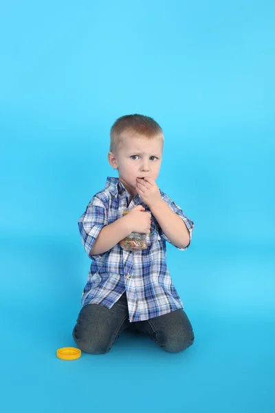 Cute little smiling boy with the candies — Stock Photo, Image