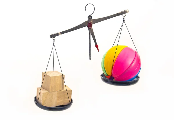 Wooden and plastic toys symbolically weighed on the scales. — Stock Photo, Image