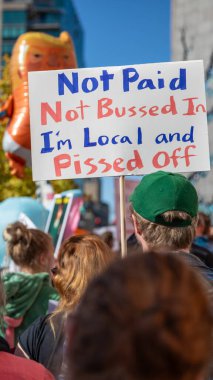 Boise, Idaho - October 18, 2025: A sign is held by a man that says 