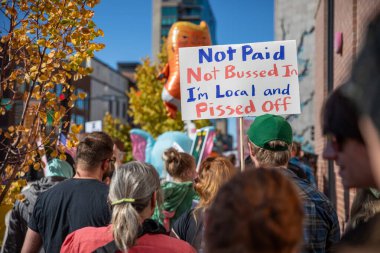 Boise, Idaho - October 18, 2025: vertical image of a sign is held by a man that says 