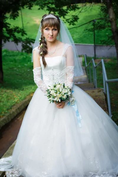 Bride standing on a staircase — Stock Photo, Image