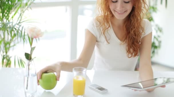 Chica sentada en la mesa usando touchpad — Vídeos de Stock