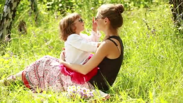 Moeder en baby zittend op het gras — Stockvideo