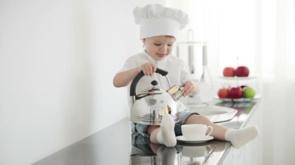 Boy pretending to  pour from pot — Stock Video