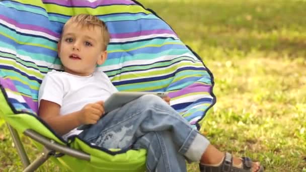 Boy playing with tablet — Stock Video