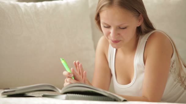 Chica alegre acostada en la escritura del sofá — Vídeos de Stock