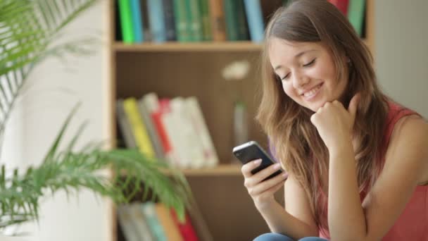 Girl relaxing on sofa using  phone — Stock Video