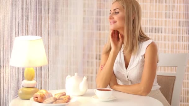 Happy young woman sitting at table — Stock Video