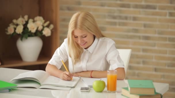 Chica sentada en escritorio estudiando — Vídeos de Stock