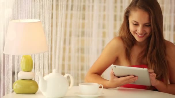 Charming girl sitting at table — Stock Video